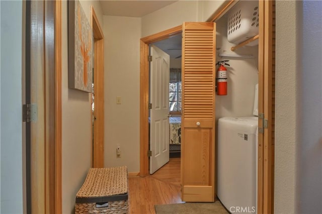 hall featuring light hardwood / wood-style floors and washer / clothes dryer