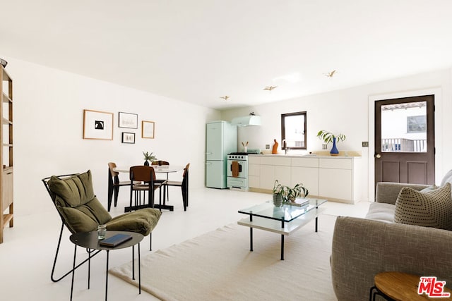 living room featuring sink and a healthy amount of sunlight