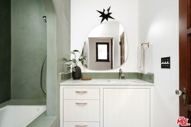 bathroom featuring a tub and vanity