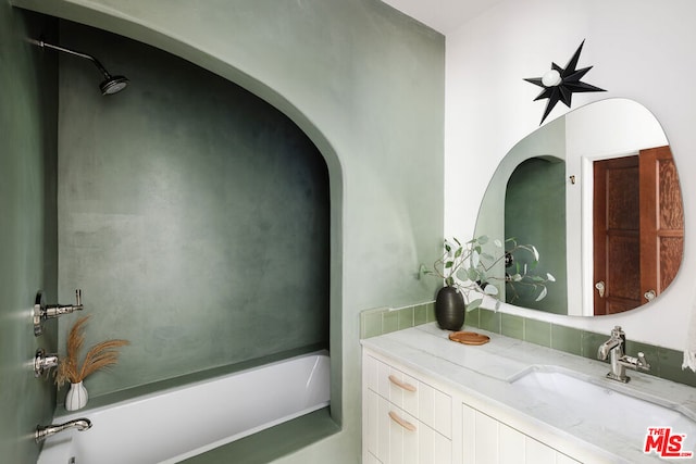 bathroom featuring a washtub and vanity