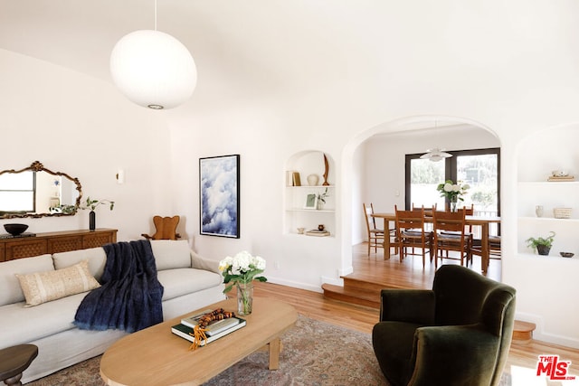 living room with light hardwood / wood-style floors and built in features