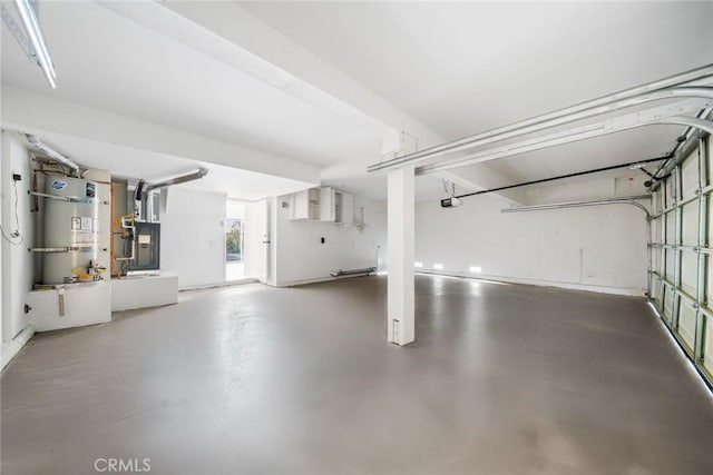 garage featuring heating unit and water heater