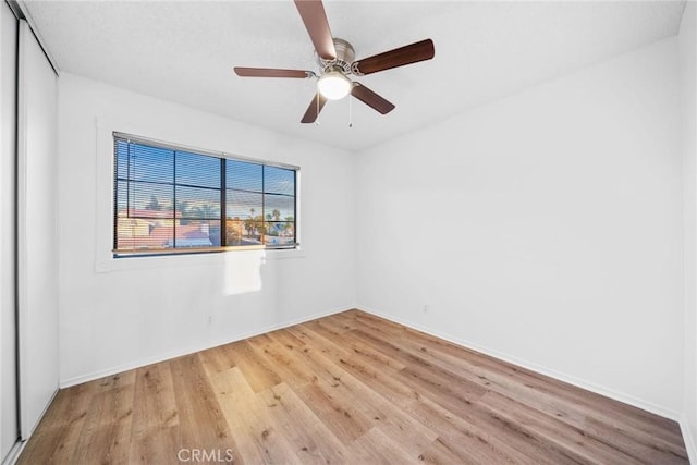 empty room featuring ceiling fan and light hardwood / wood-style flooring