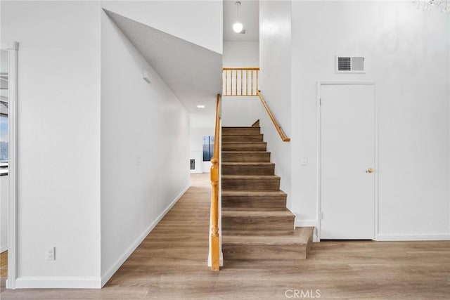 stairs with hardwood / wood-style flooring