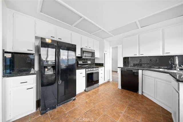 kitchen featuring backsplash, white cabinets, and black appliances