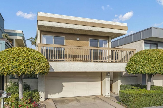 view of front facade featuring a balcony and a garage