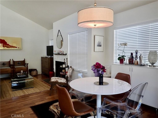 dining area with dark hardwood / wood-style floors and lofted ceiling