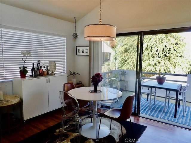 dining room featuring dark hardwood / wood-style flooring and lofted ceiling