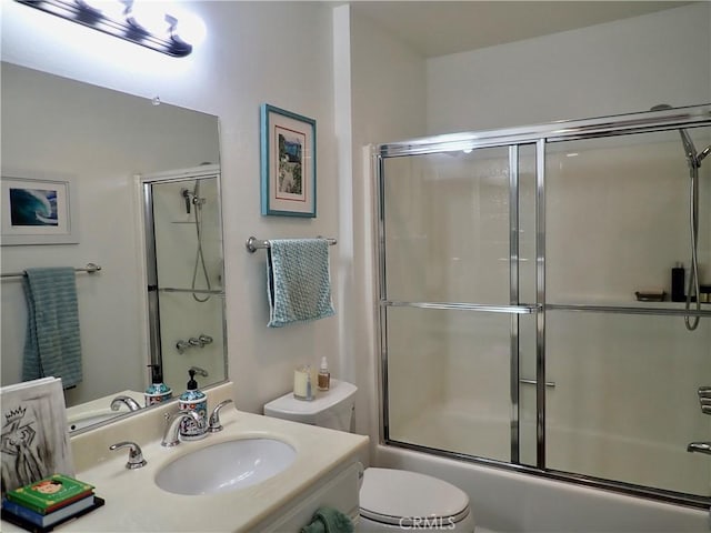 full bathroom featuring shower / bath combination with glass door, sink, and toilet