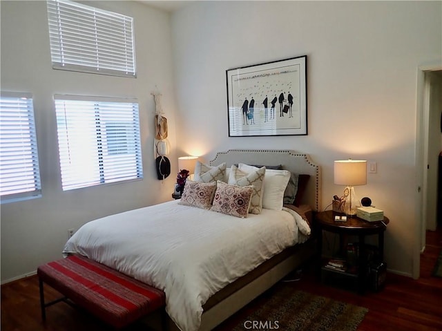 bedroom with dark hardwood / wood-style floors