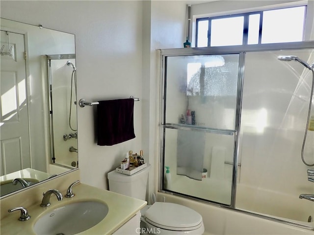 full bathroom featuring vanity, toilet, and enclosed tub / shower combo