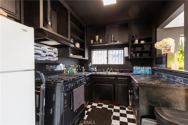 kitchen featuring dark stone counters, sink, dark brown cabinets, white fridge, and black range with gas cooktop