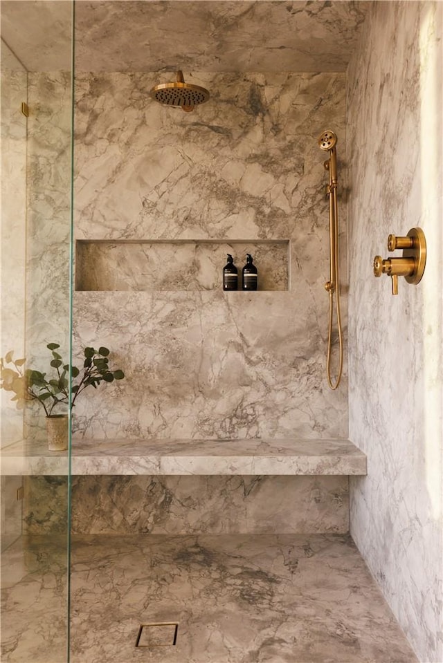 bathroom with a tile shower