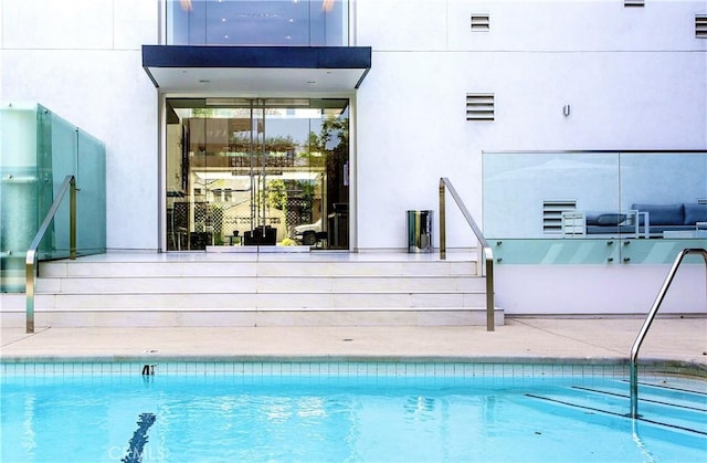 view of pool featuring a patio area