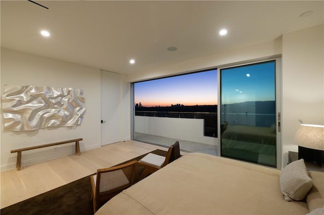 bedroom featuring access to outside and hardwood / wood-style floors