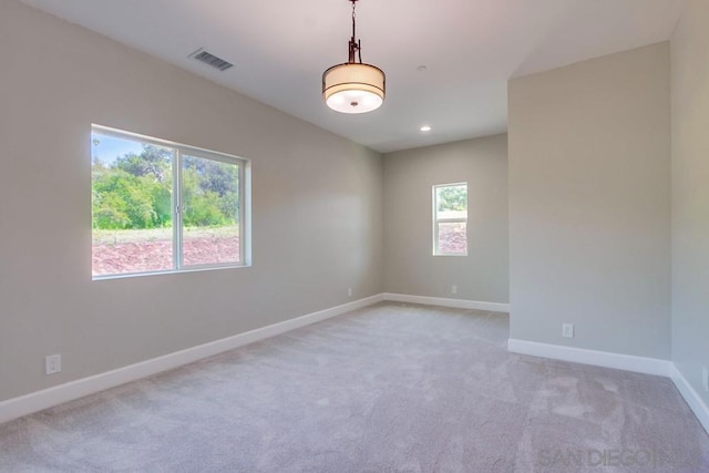 spare room with light colored carpet