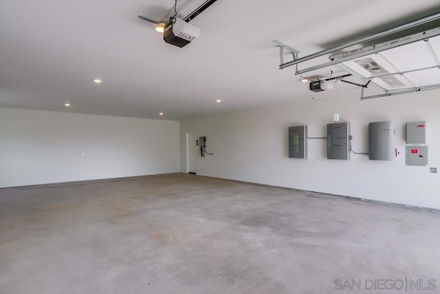 garage with electric panel and a garage door opener