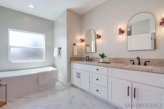 bathroom featuring vanity and a bathtub