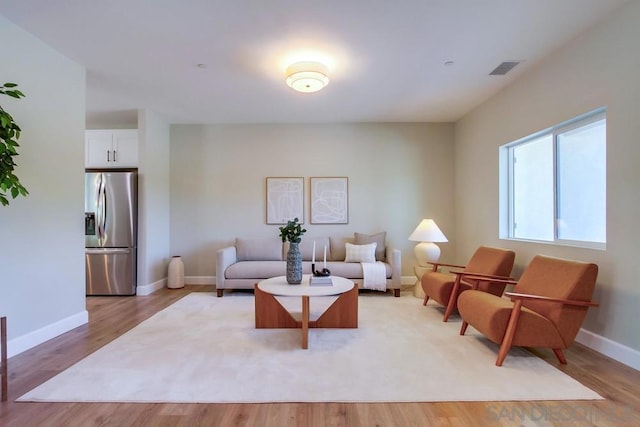 living room with light hardwood / wood-style flooring