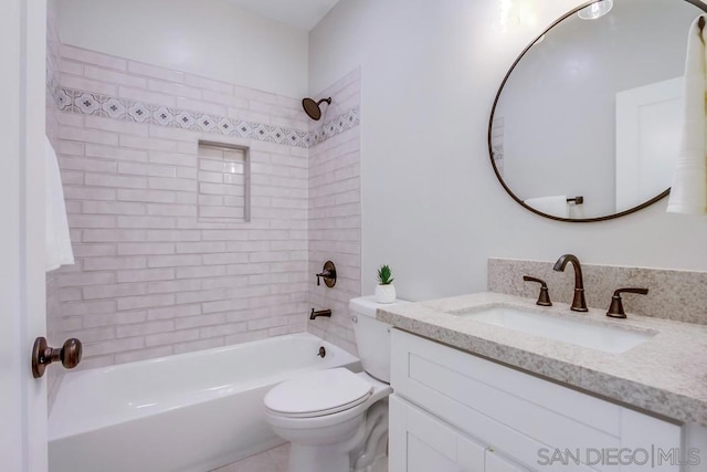 full bathroom with vanity, toilet, and tiled shower / bath