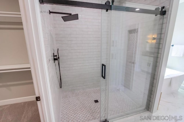 bathroom featuring a shower with door