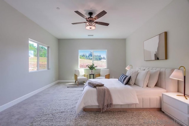 bedroom featuring light colored carpet and ceiling fan