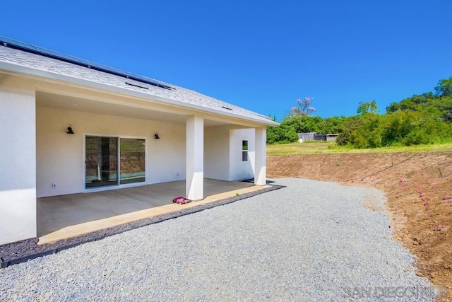 exterior space with solar panels and a patio area