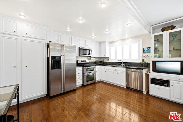 kitchen featuring white cabinets, appliances with stainless steel finishes, dark hardwood / wood-style flooring, and sink