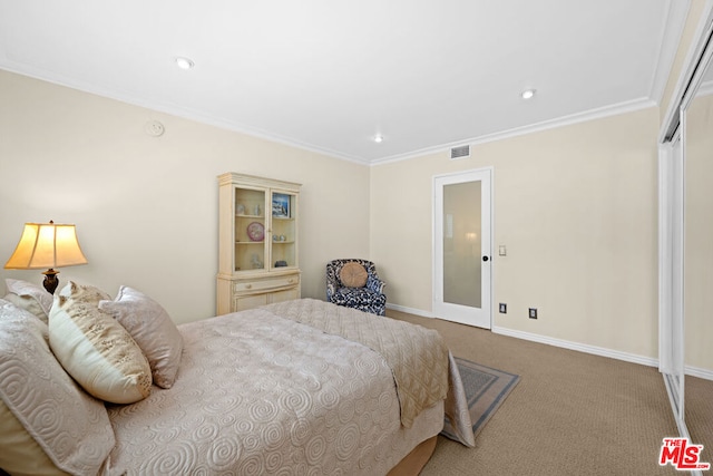 carpeted bedroom featuring a closet and ornamental molding