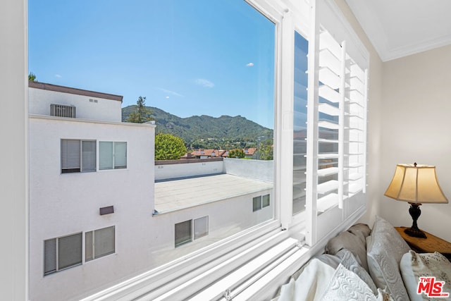 interior space with a mountain view and ornamental molding