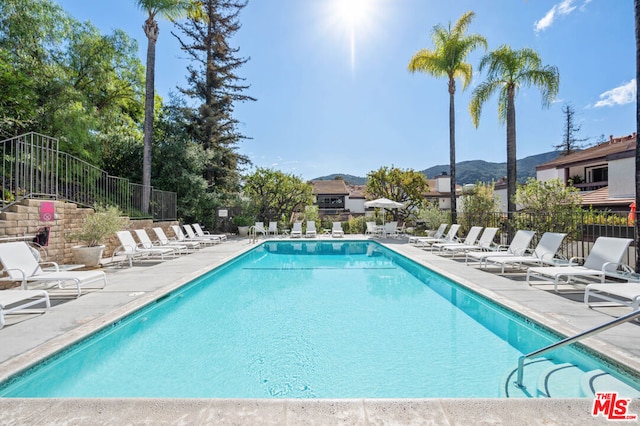 view of pool featuring a mountain view and a patio