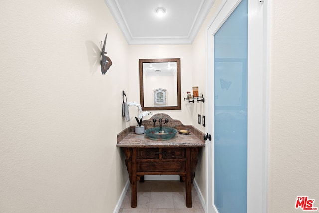 bathroom with tile patterned flooring, vanity, and ornamental molding