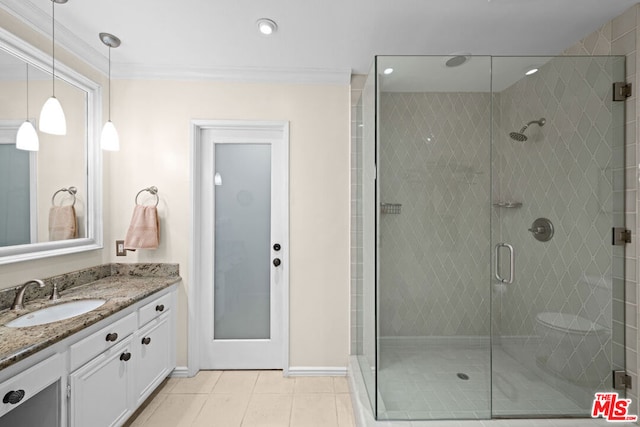 bathroom with tile patterned flooring, vanity, an enclosed shower, and ornamental molding