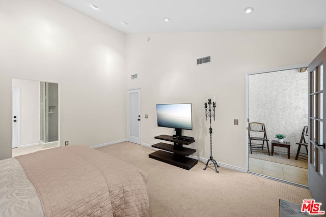 bedroom with high vaulted ceiling and light colored carpet