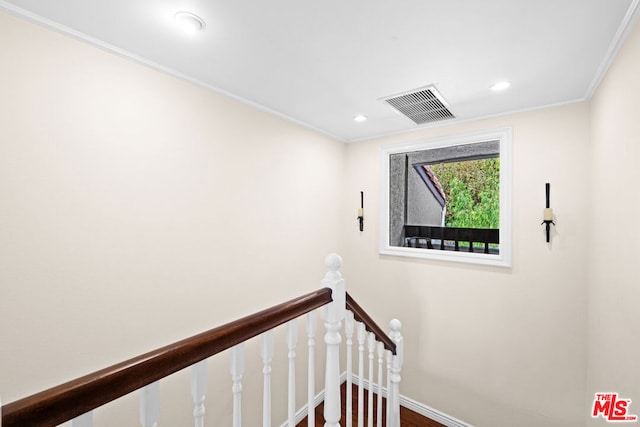 stairs featuring crown molding