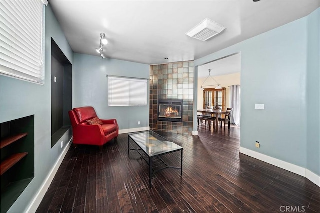 living room featuring hardwood / wood-style floors and a tile fireplace