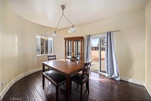 dining space with dark hardwood / wood-style flooring