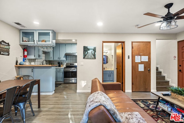 living room with ceiling fan, hardwood / wood-style floors, and sink