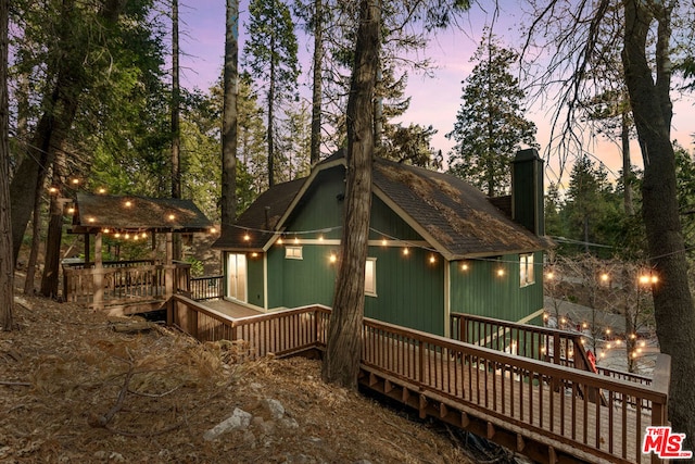 view of back house at dusk