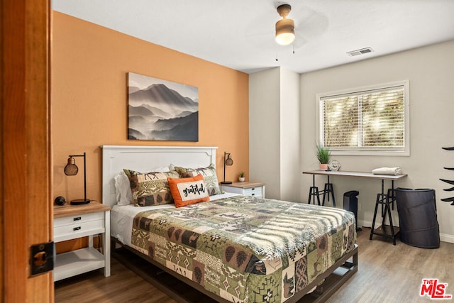 bedroom with hardwood / wood-style flooring and ceiling fan