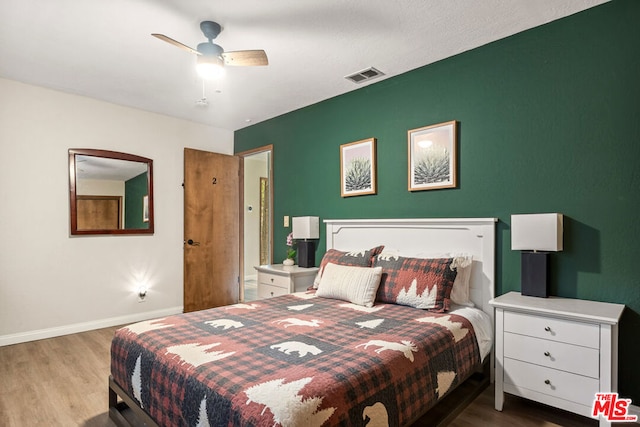 bedroom with light hardwood / wood-style floors and ceiling fan