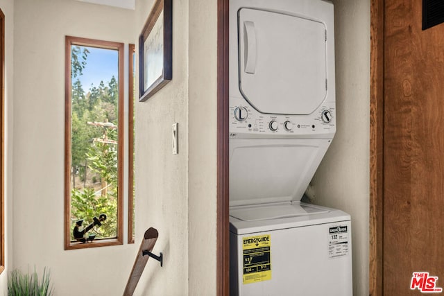 washroom featuring stacked washer / dryer