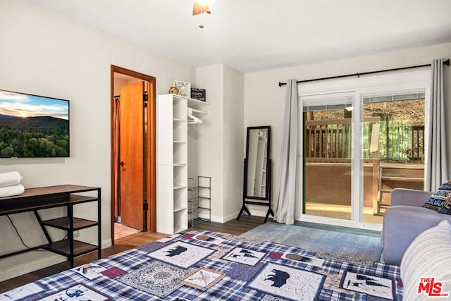 bedroom with dark hardwood / wood-style flooring, access to outside, and ceiling fan