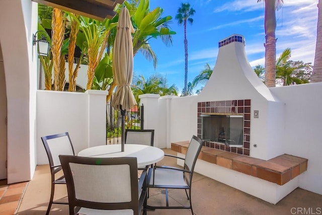 view of patio / terrace featuring exterior fireplace