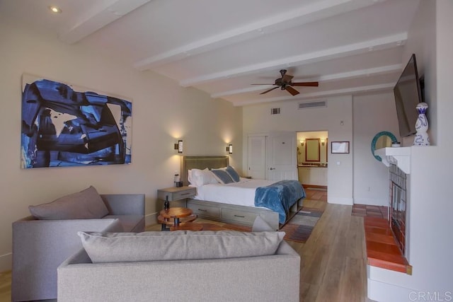 bedroom with beamed ceiling, ceiling fan, and wood-type flooring