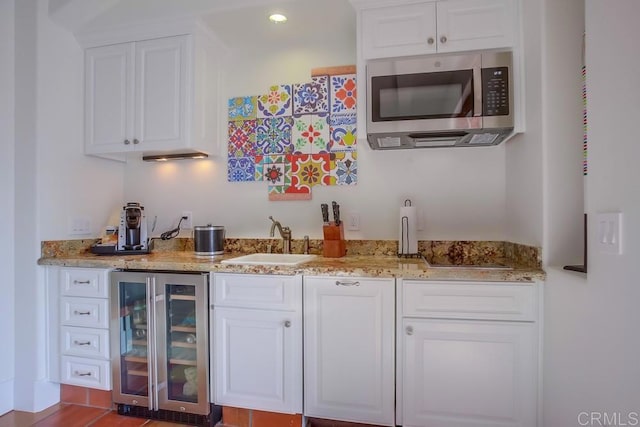 bar featuring white cabinetry, sink, and wine cooler