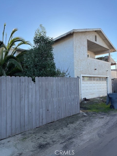 view of side of home featuring a garage