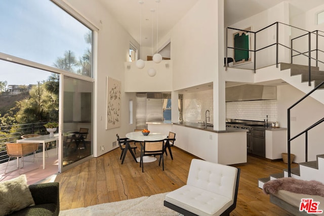 interior space featuring hardwood / wood-style floors, a towering ceiling, and sink