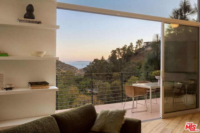 balcony at dusk featuring a mountain view