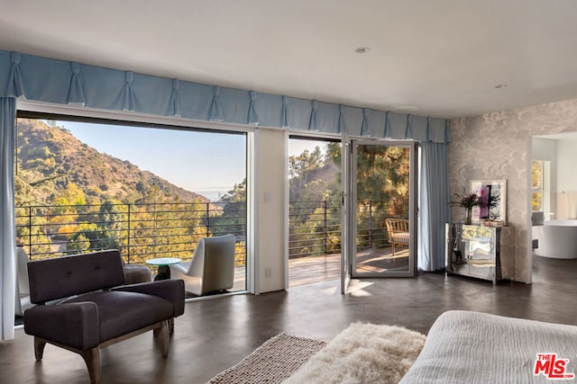 sitting room featuring a mountain view and plenty of natural light